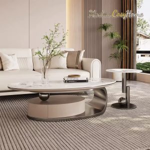Contemporary living room with a white sectional, round marble coffee table, and tall indoor plants by a sunlit window.